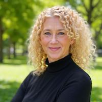 A bio picture of Christy J. Colby against a vibrant green backdrop.